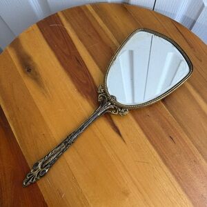 1960s Hollywood Regency cherub gold tone handheld mirror